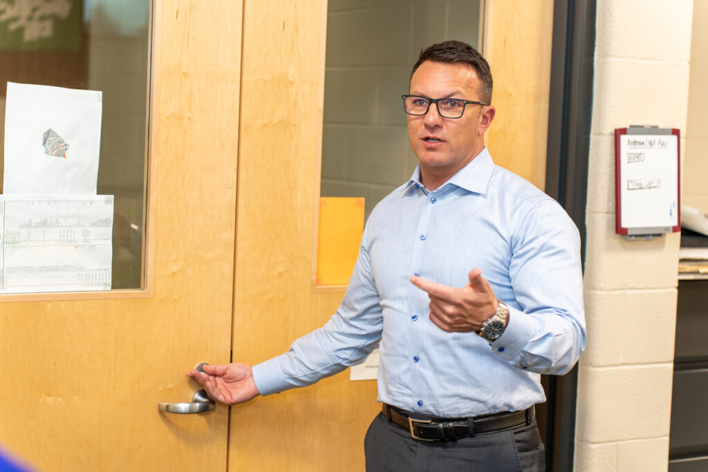 Jason Russell reviews a school door during a site security assessment.